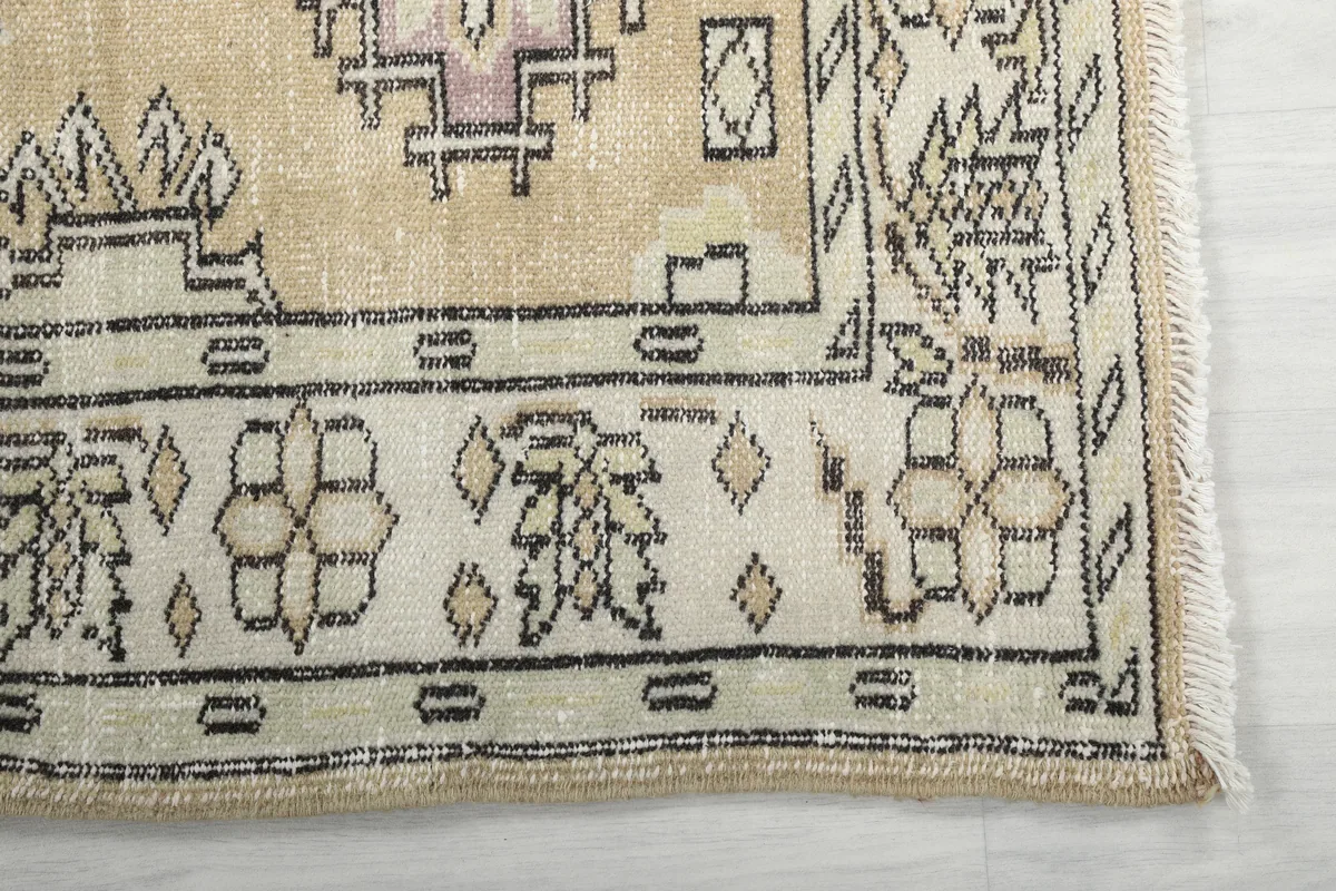 Corner detail of the Beige Tribal Geometric Rug, showing the border pattern and fringe.