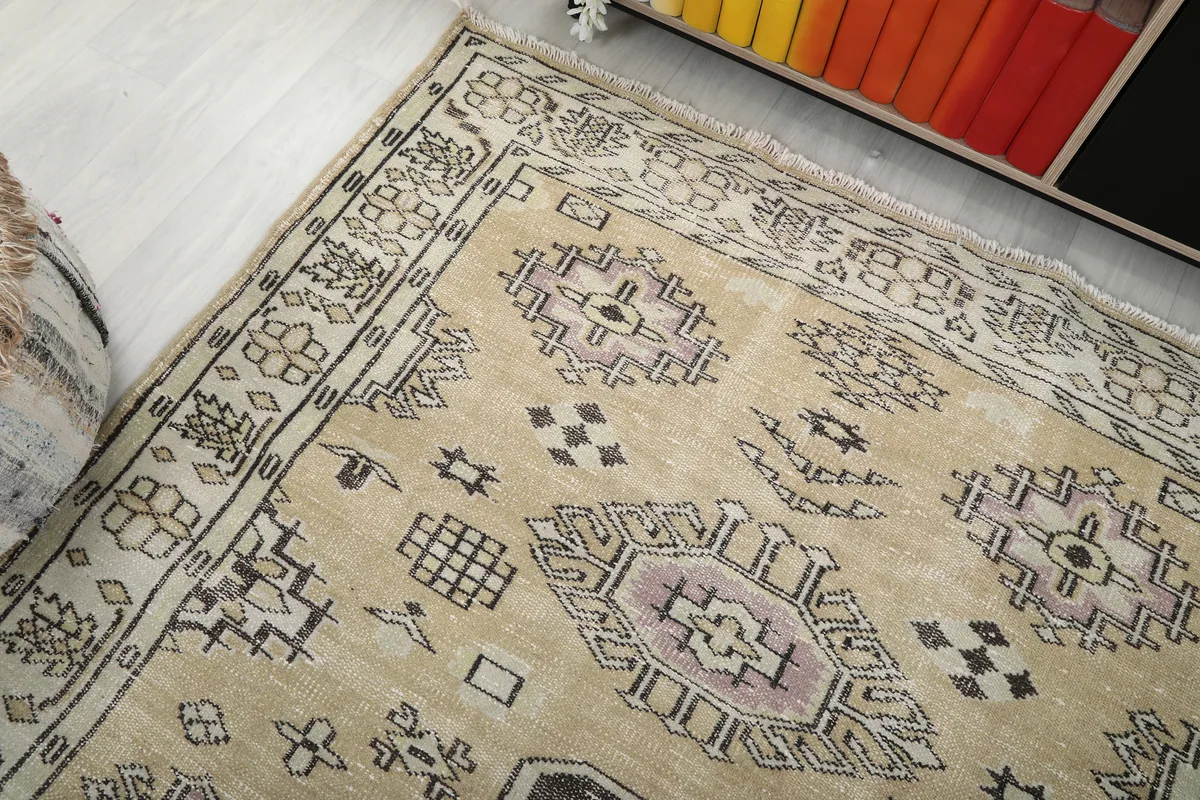 Angled view of the Beige Tribal Geometric Rug, showing the blend of colors and motifs.