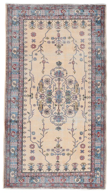 Full overhead view of the 5x9 cream and blue vintage Anatolian rug