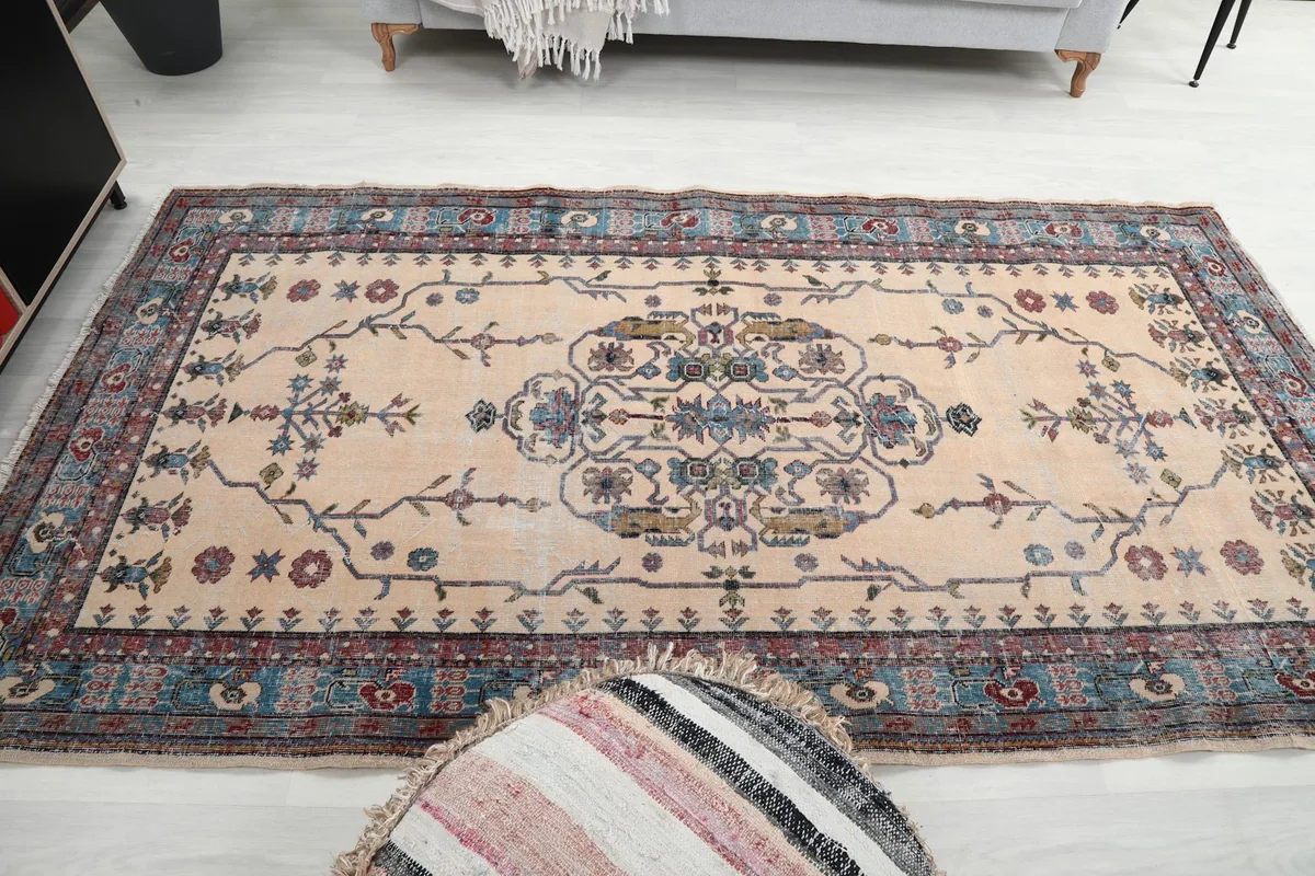 Wide shot of the vintage rug in a living space, demonstrating its scale and aesthetic appeal