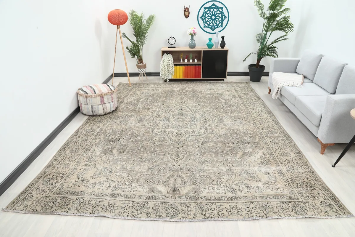 Oversized gray and beige vintage rug displayed in a modern living room setting