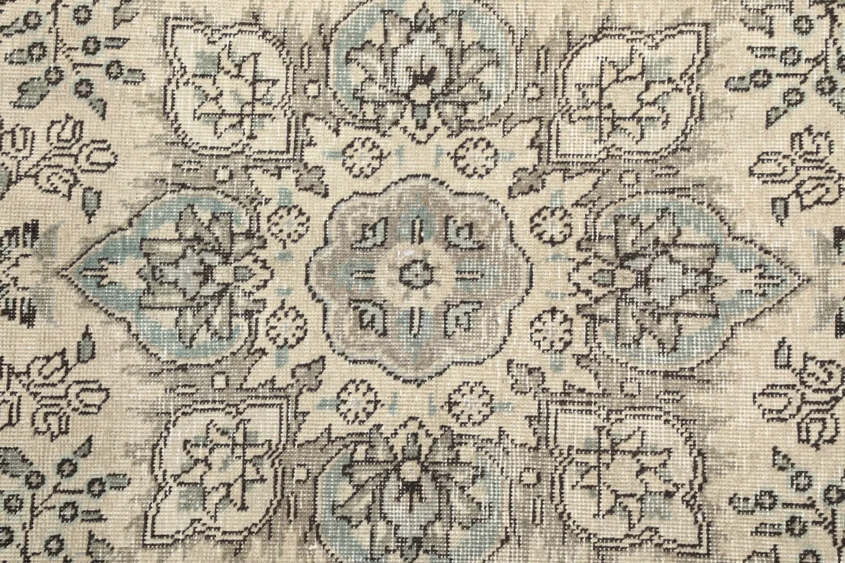 Close-up of the central medallion with intricate floral and geometric details in gray and blue