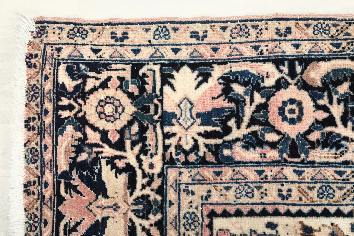 Close-up detail of the Rose Navy Floral Medallion Rug's corner, showing the intricate floral motifs and border patterns.
