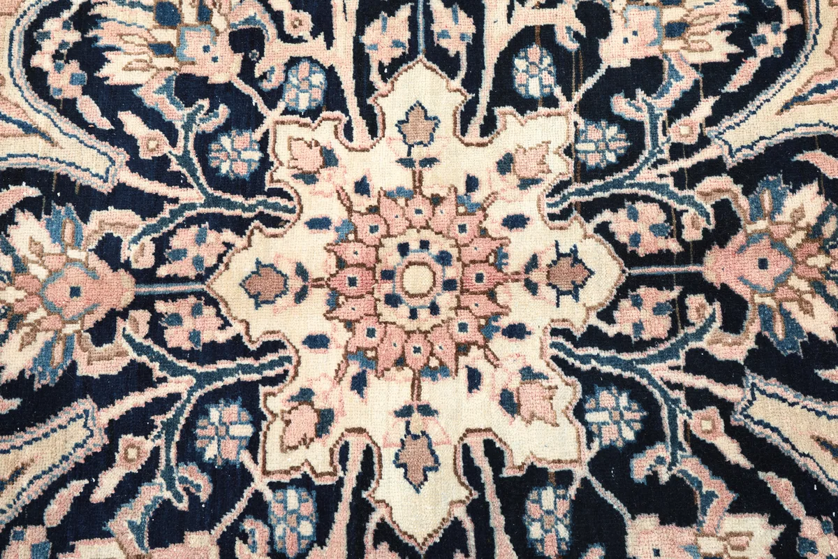 Detailed view of the Rose Navy Floral Medallion Rug's central medallion, revealing the fine knotting and color blend.