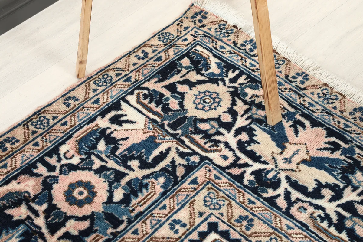 Close-up of the Rose Navy Floral Medallion Rug's corner border, showing the geometric and floral elements.