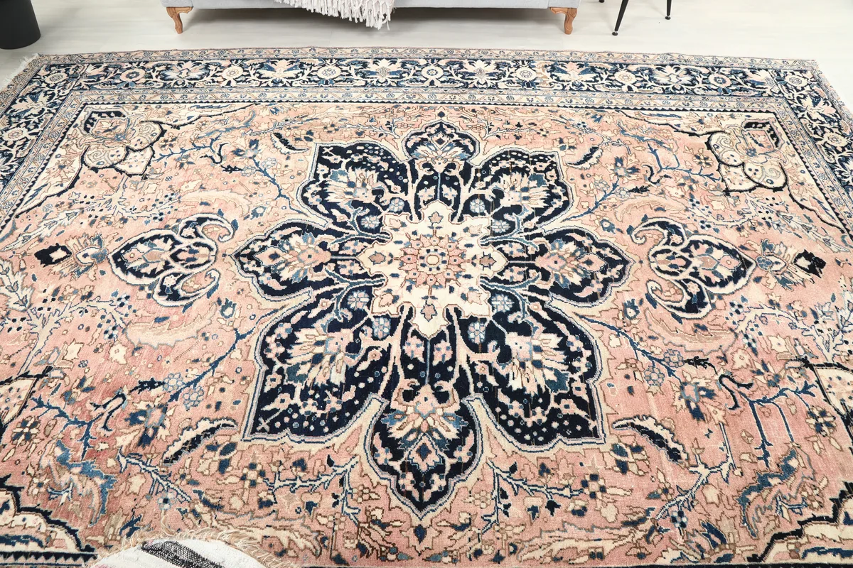 Rose Navy Floral Medallion Rug from a slightly lower angle, showcasing the central design and surrounding motifs.