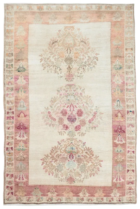 Full overhead view of the ivory and rose floral vintage Anatolian area rug