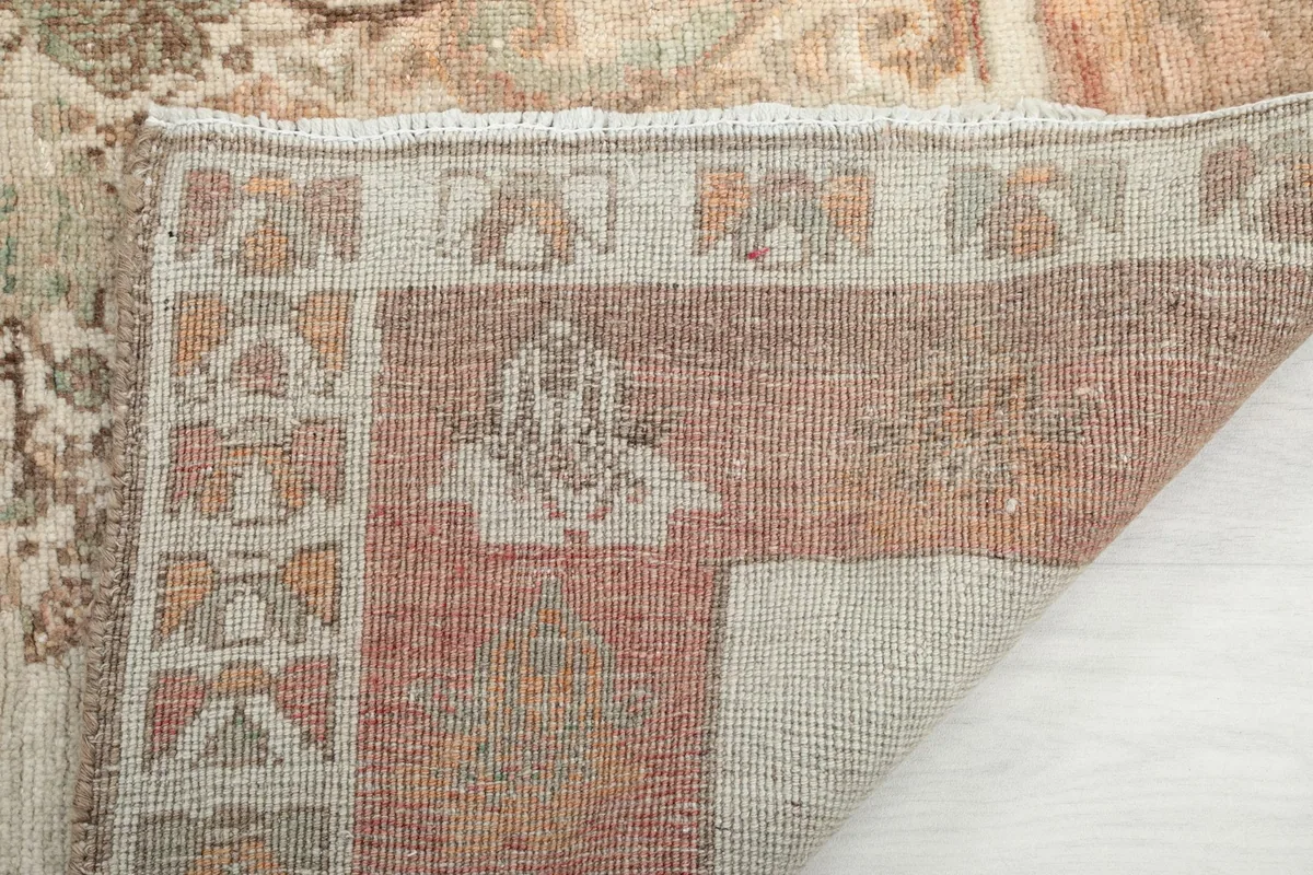 Close-up of the back of the rug, showing the knotting detail and wool pile on cotton