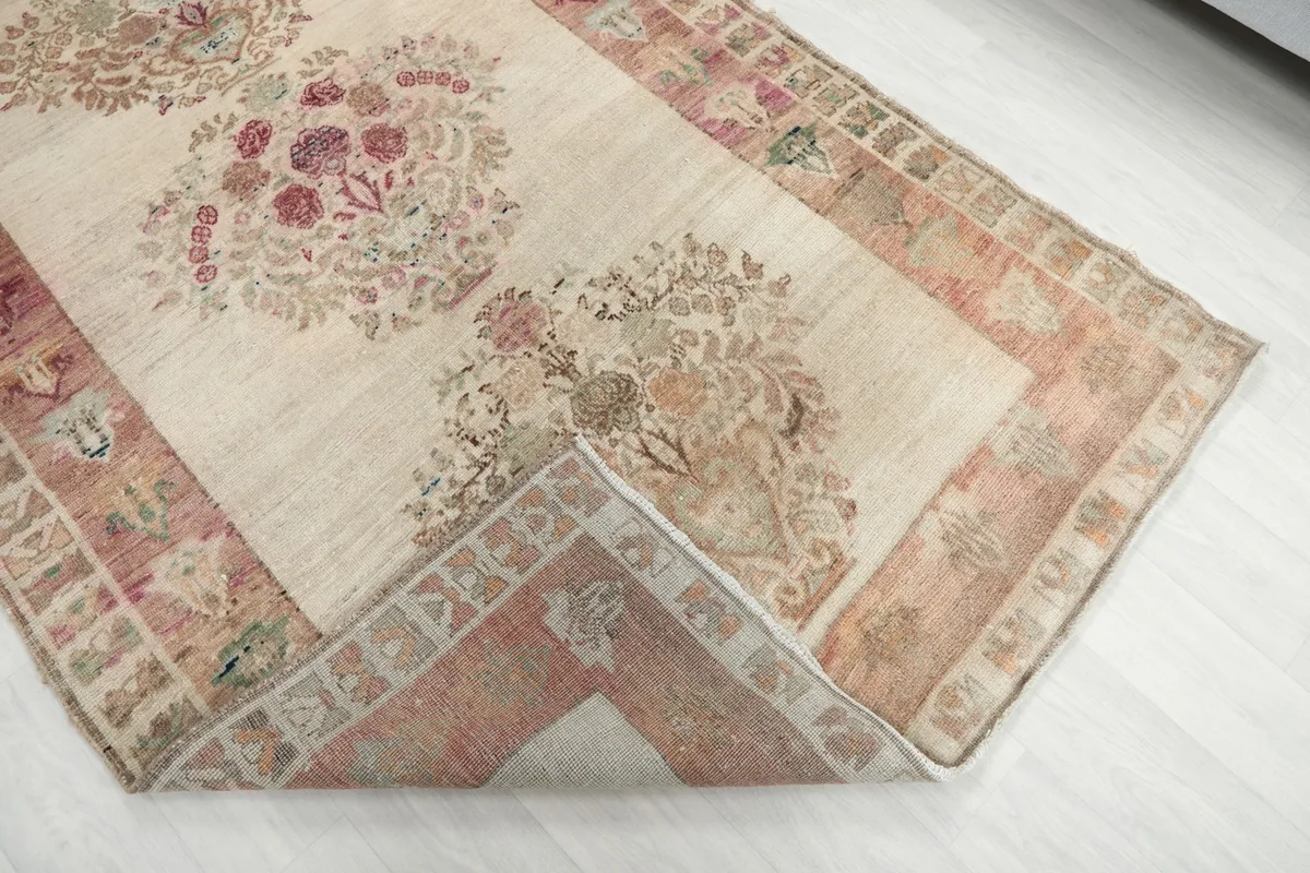 Folded corner of the rug revealing the cotton foundation and hand-knotted construction