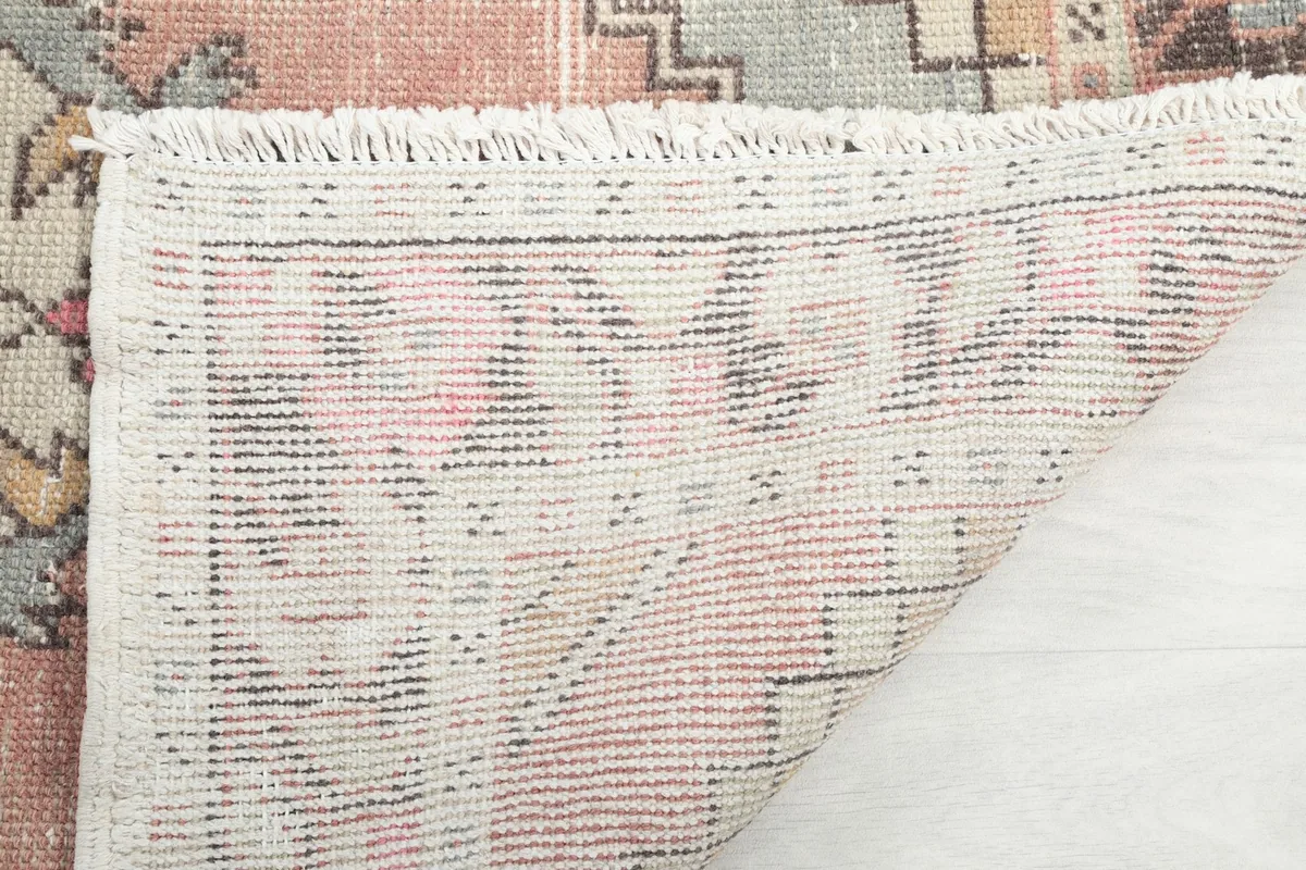 Close-up of the rug's fringe and the tightly woven cotton foundation