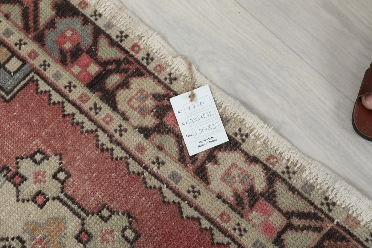Rug tag showing product information and a close-up of the rug's border texture