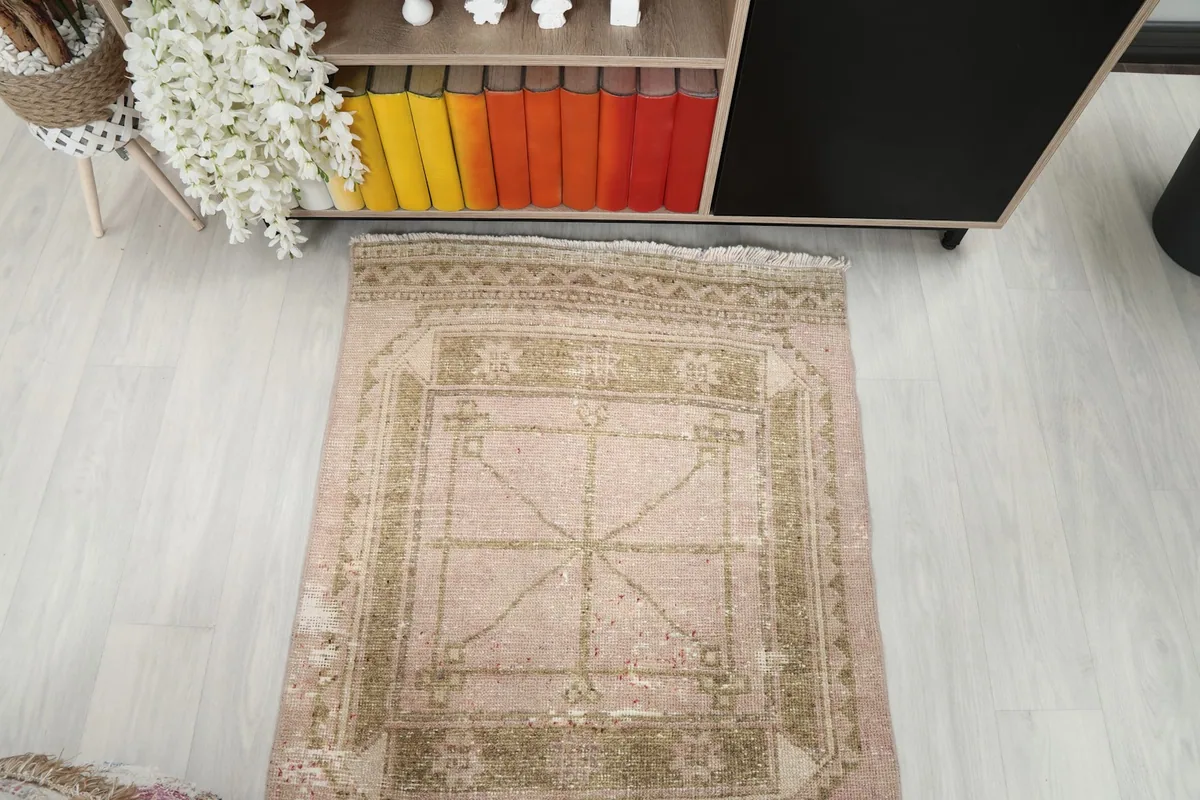 Overhead shot of one end of the runner, displaying the repeating geometric patterns and aged patina.