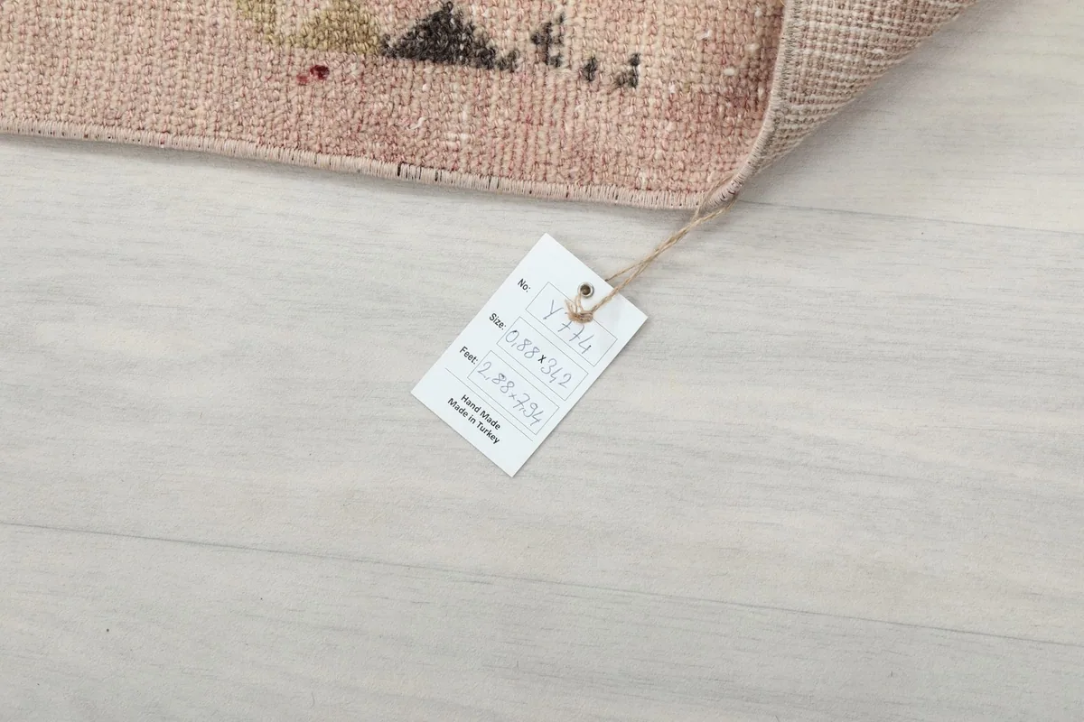 Product tag attached to the rug, displaying its dimensions and origin details.