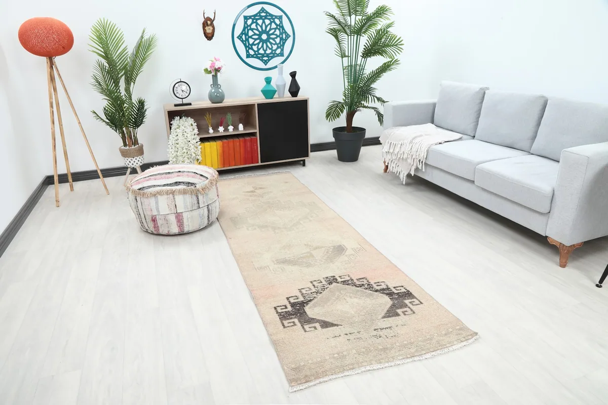 Runner rug in a room from a slightly different angle, highlighting its placement next to a sofa and ottoman.