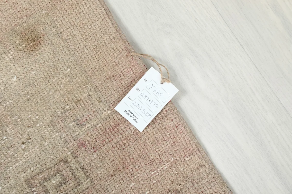Detail of the rug with a product tag, showing the unique characteristics and authenticity.
