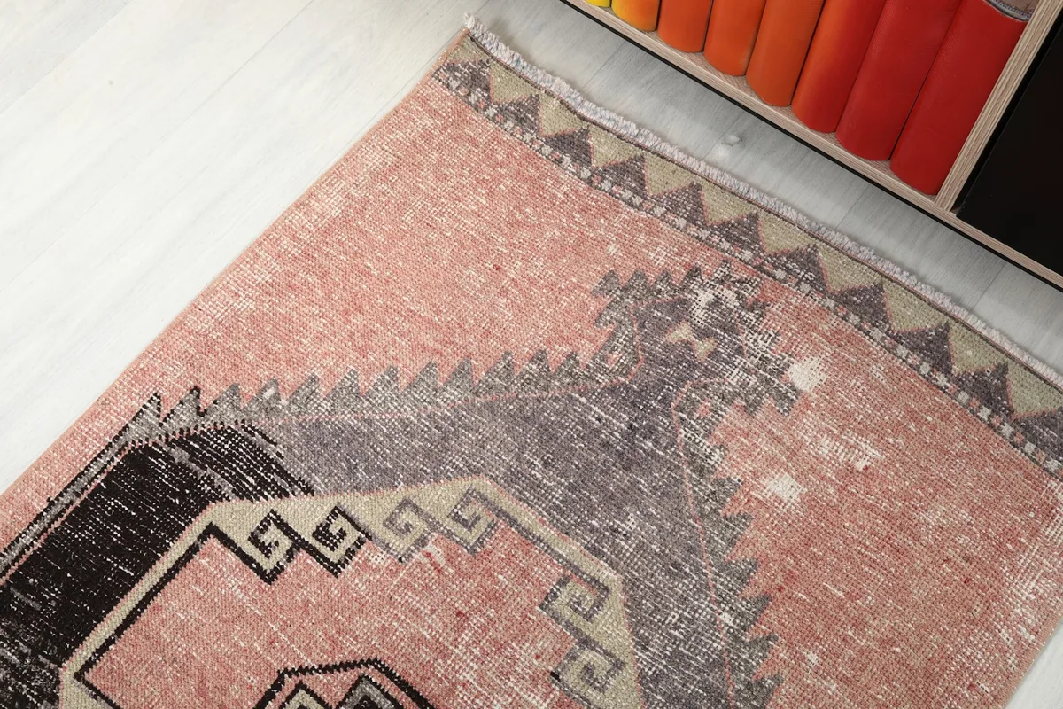 Top-down angle showing the distressed areas and color variations near the rug's border