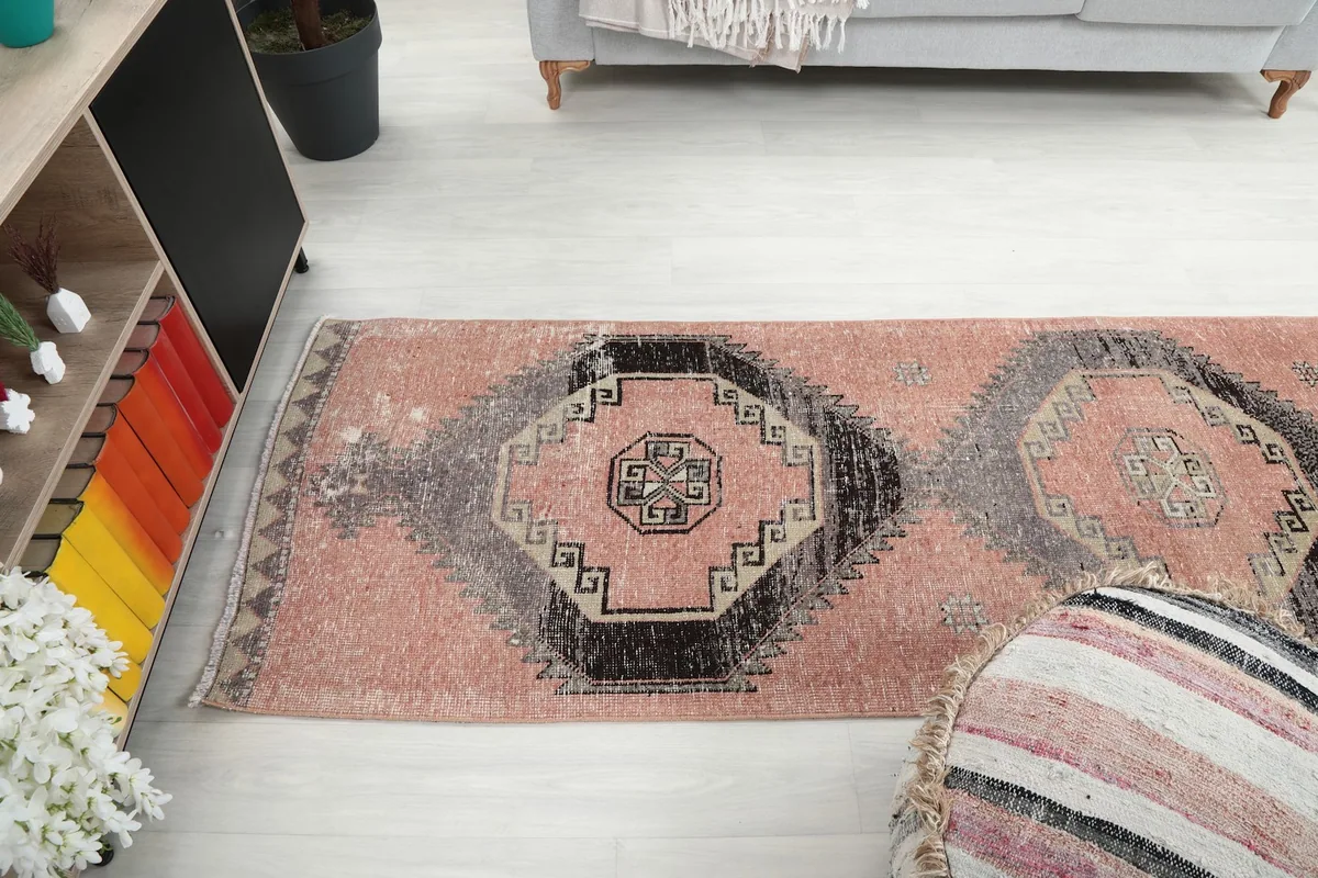 Broader room view of the runner rug from above, showing its placement relative to furniture