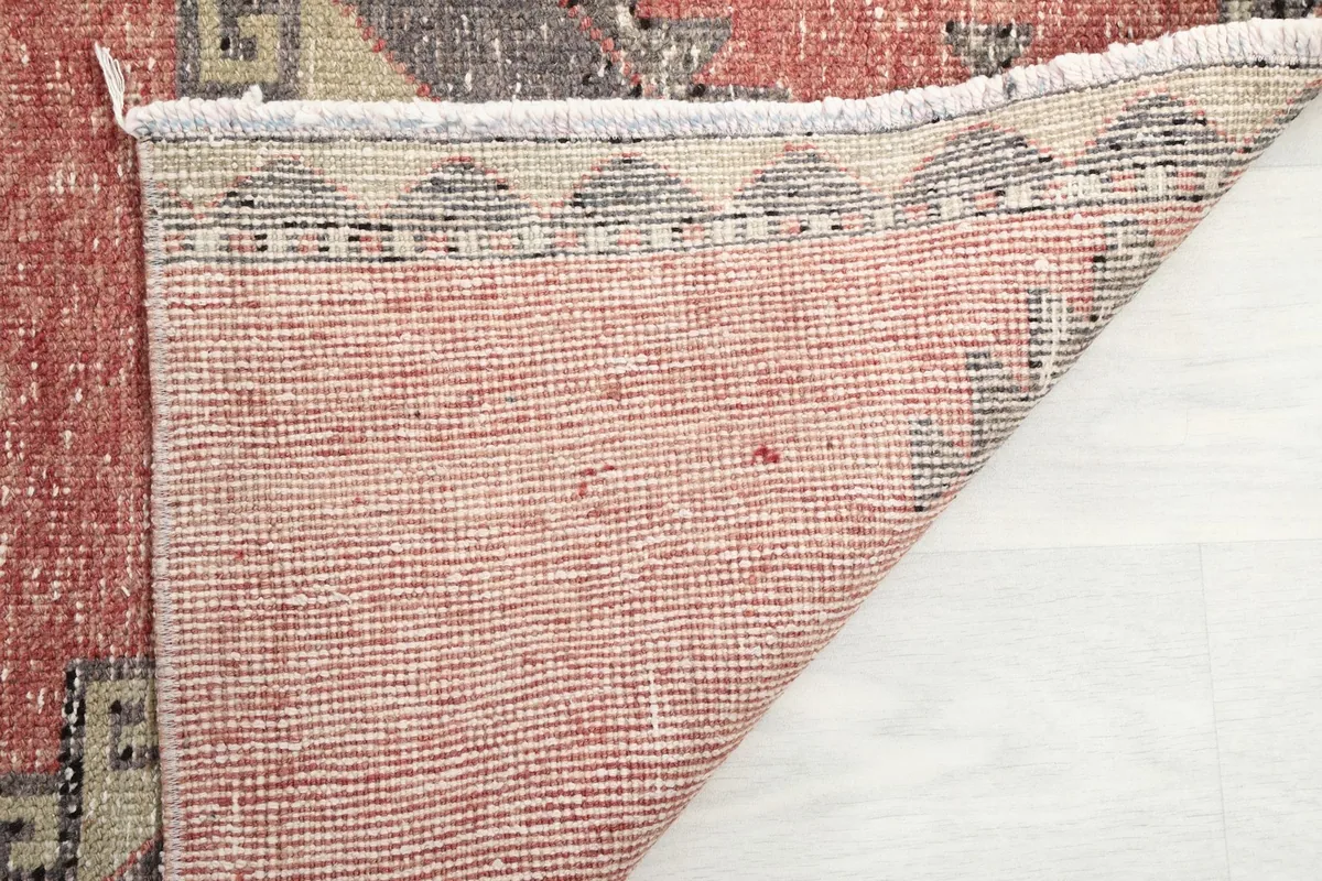 Underside of the vintage runner rug, revealing the tightly woven cotton foundation and knots