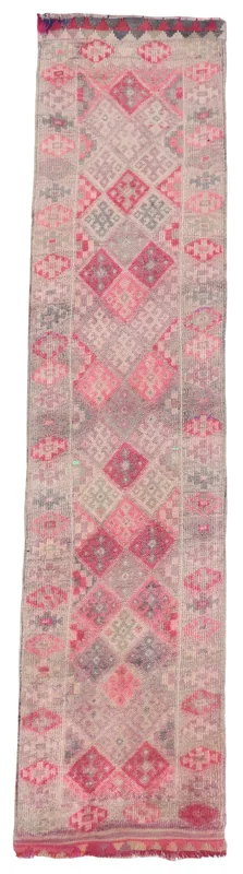 Full overhead view of the vintage Anatolian runner rug with rose and beige geometric patterns