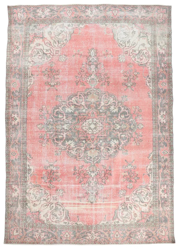 Full overhead view of a vintage rose and gray medallion area rug