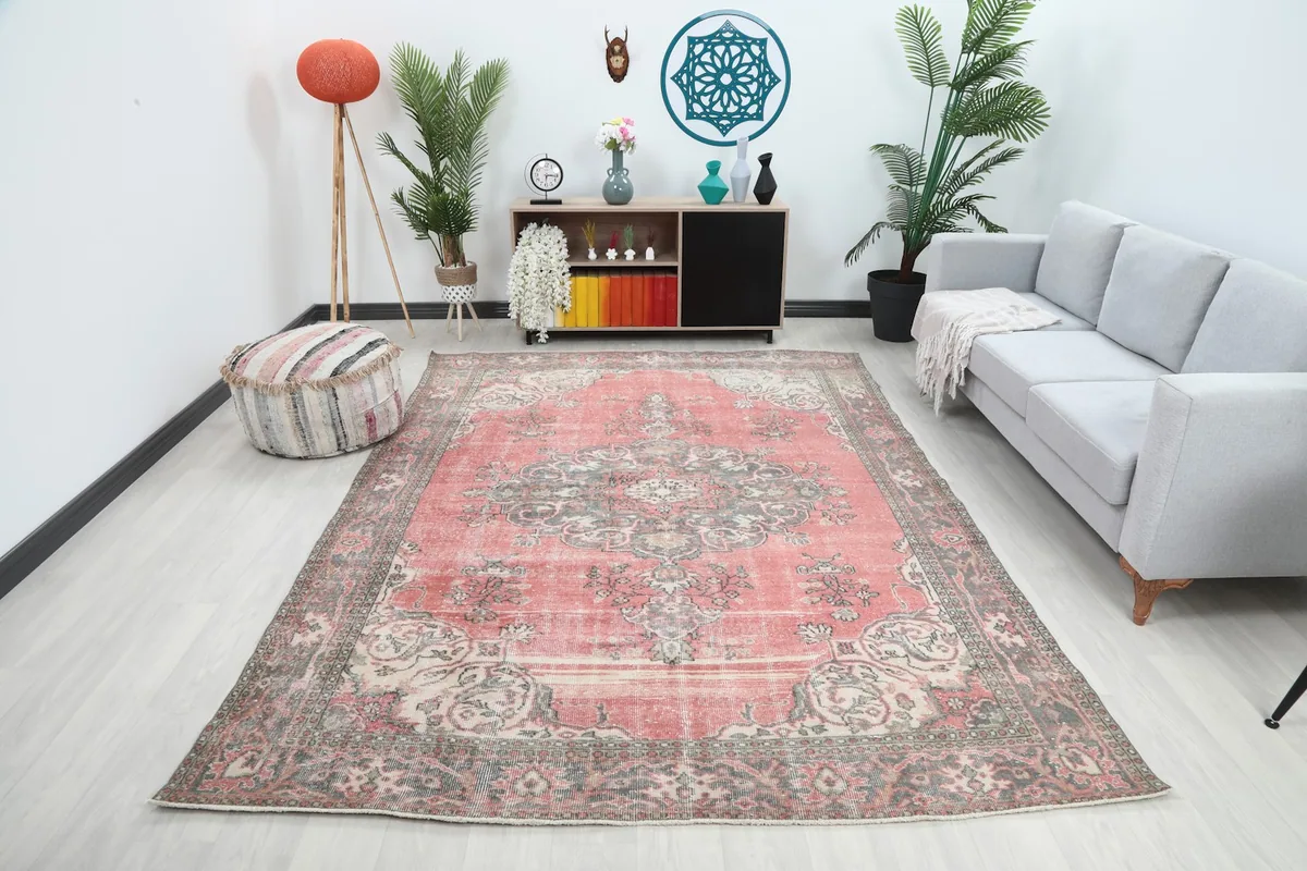 Vintage rose and gray rug in a living room setting with a gray sofa