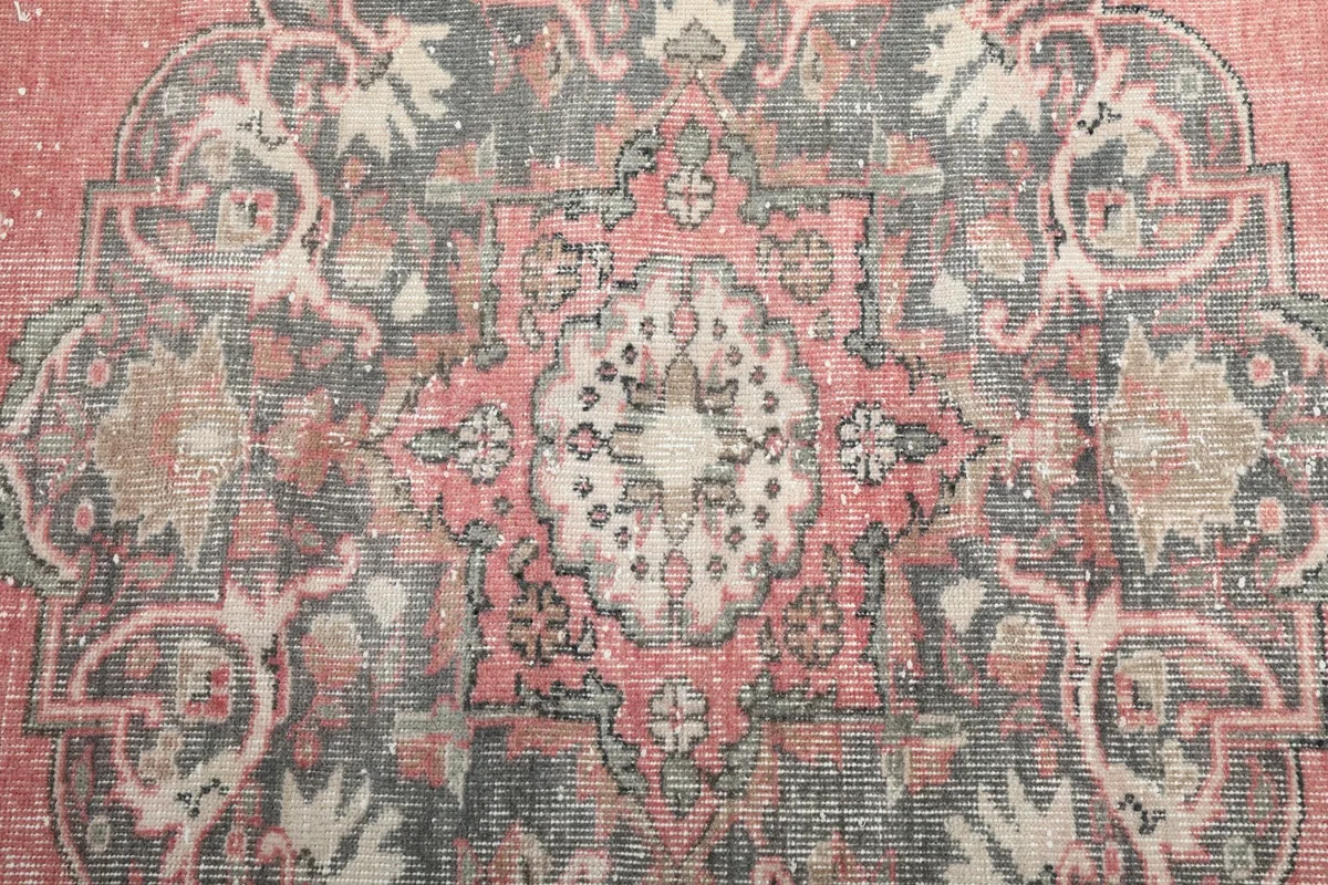 Close-up of the intricate patterns within the central medallion of the rug