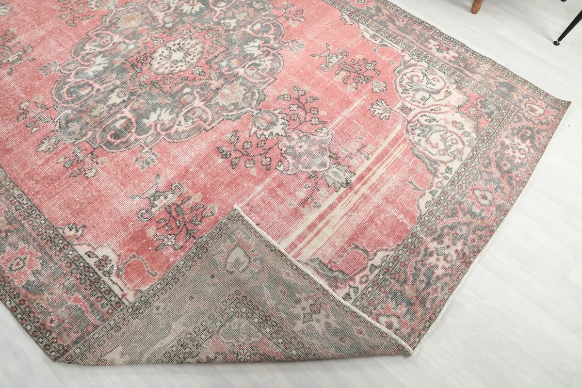 Corner of the rug folded back, revealing the backside and construction