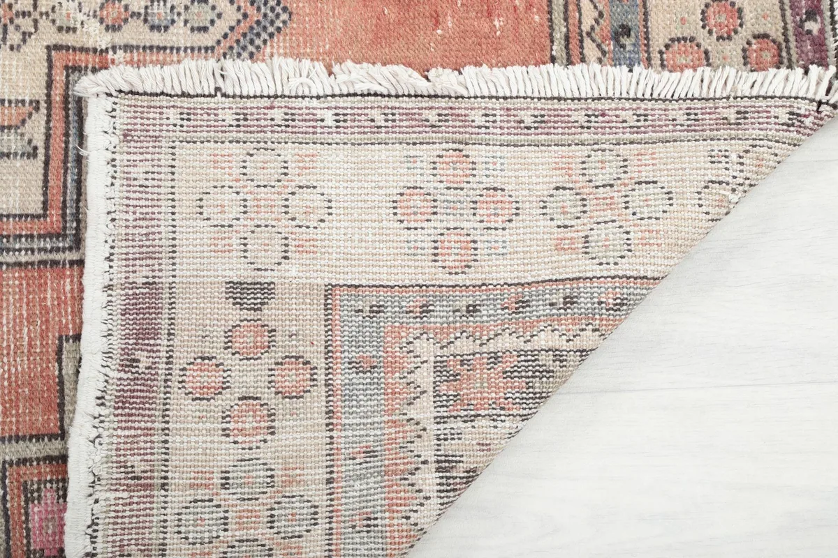 Close-up of the rug's underside, displaying the tight knotting and craftsmanship of the cotton foundation.
