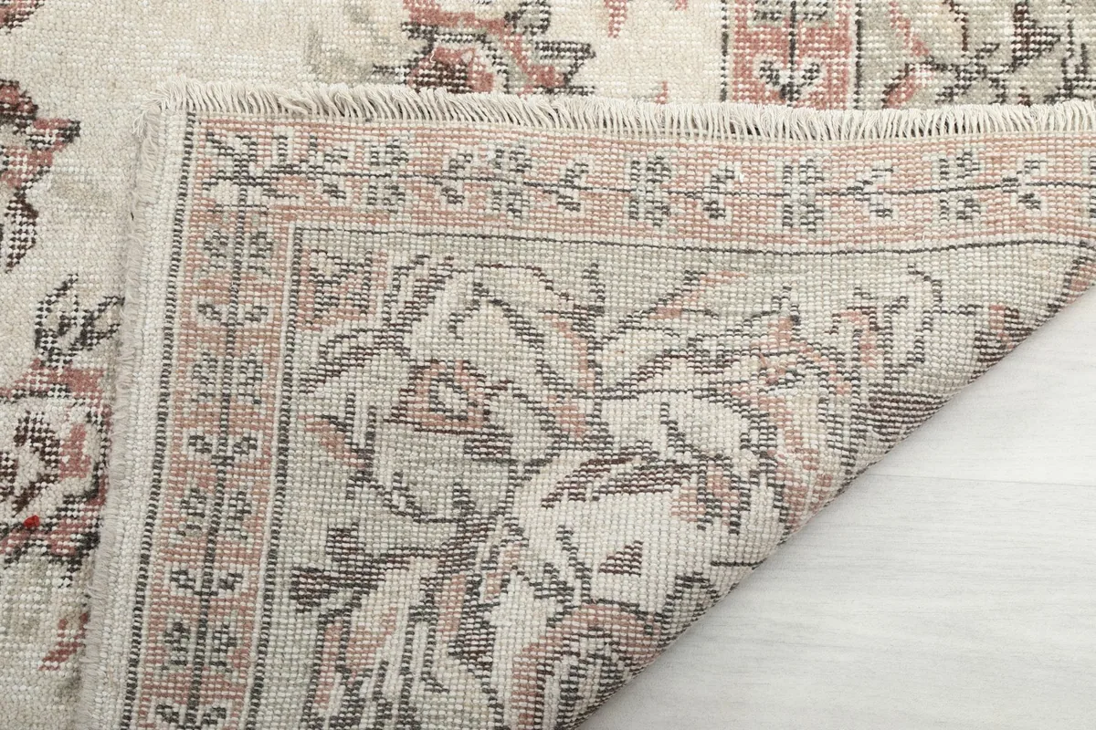 Underside of the rug, showing the cotton foundation and hand-knotted wool pile