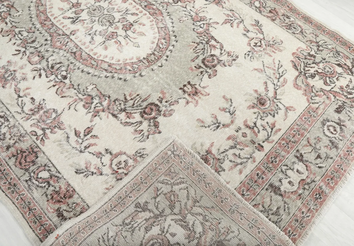 Folded corner of the rug revealing the hand-knotted construction and pile texture