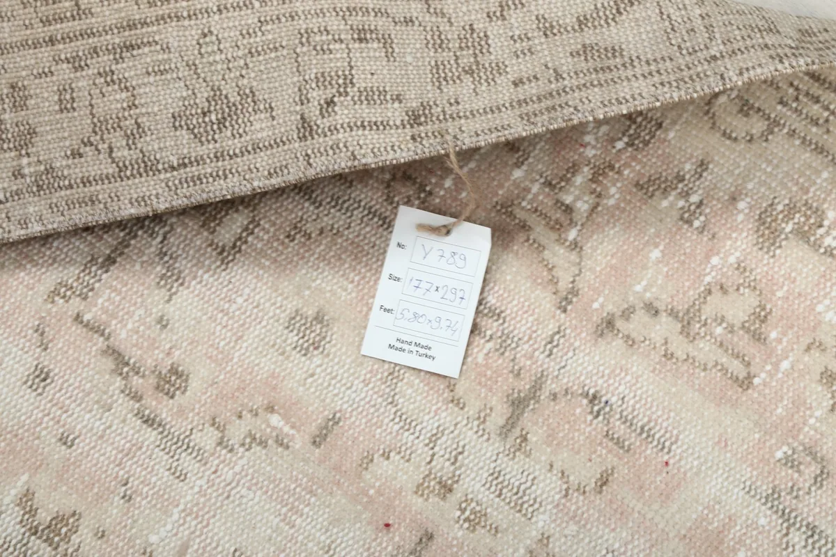 Close-up of the rug's back with a product tag, indicating its origin and material