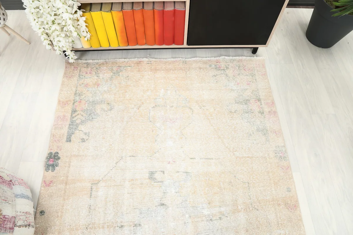 Overhead view of the rug's center and one end, showing the overall faded design.