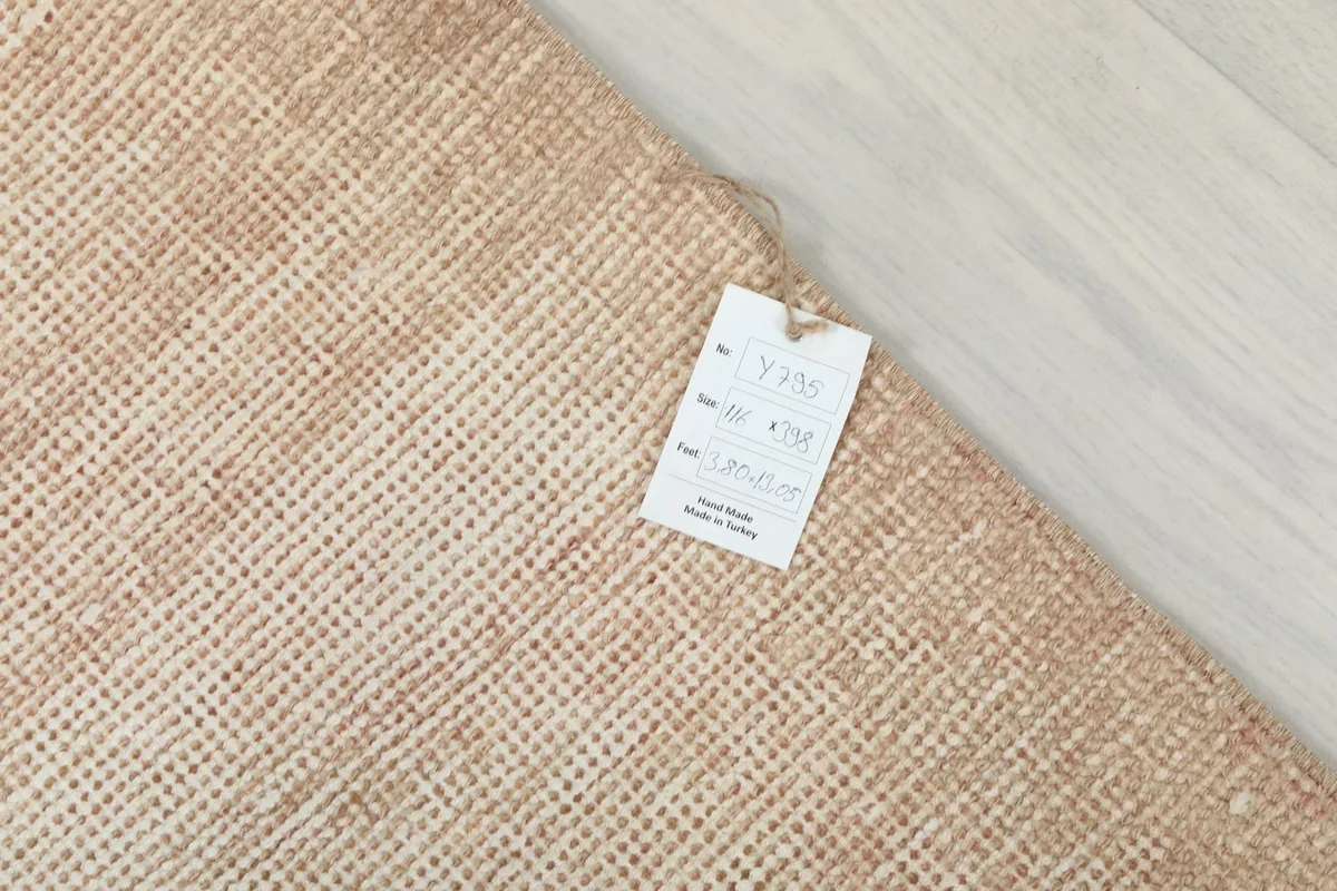 Product tag attached to the back of the rug, confirming its hand-knotted vintage origin from Turkey.