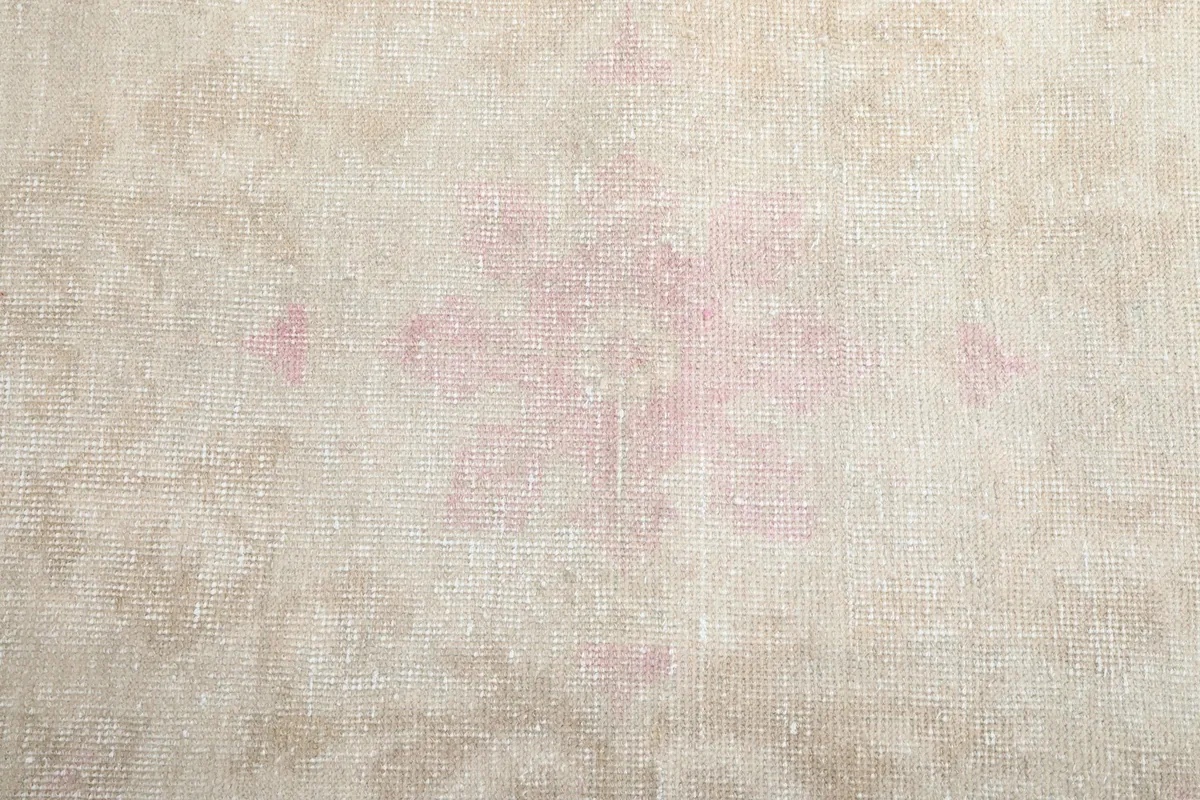 Close-up detail of the faded rose central medallion motif