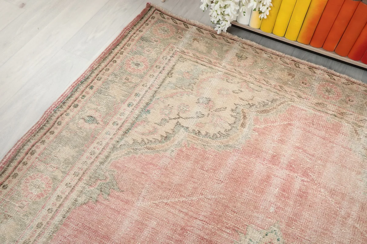 Top-down angle highlighting the rug's border and the gentle color variations in the main field.