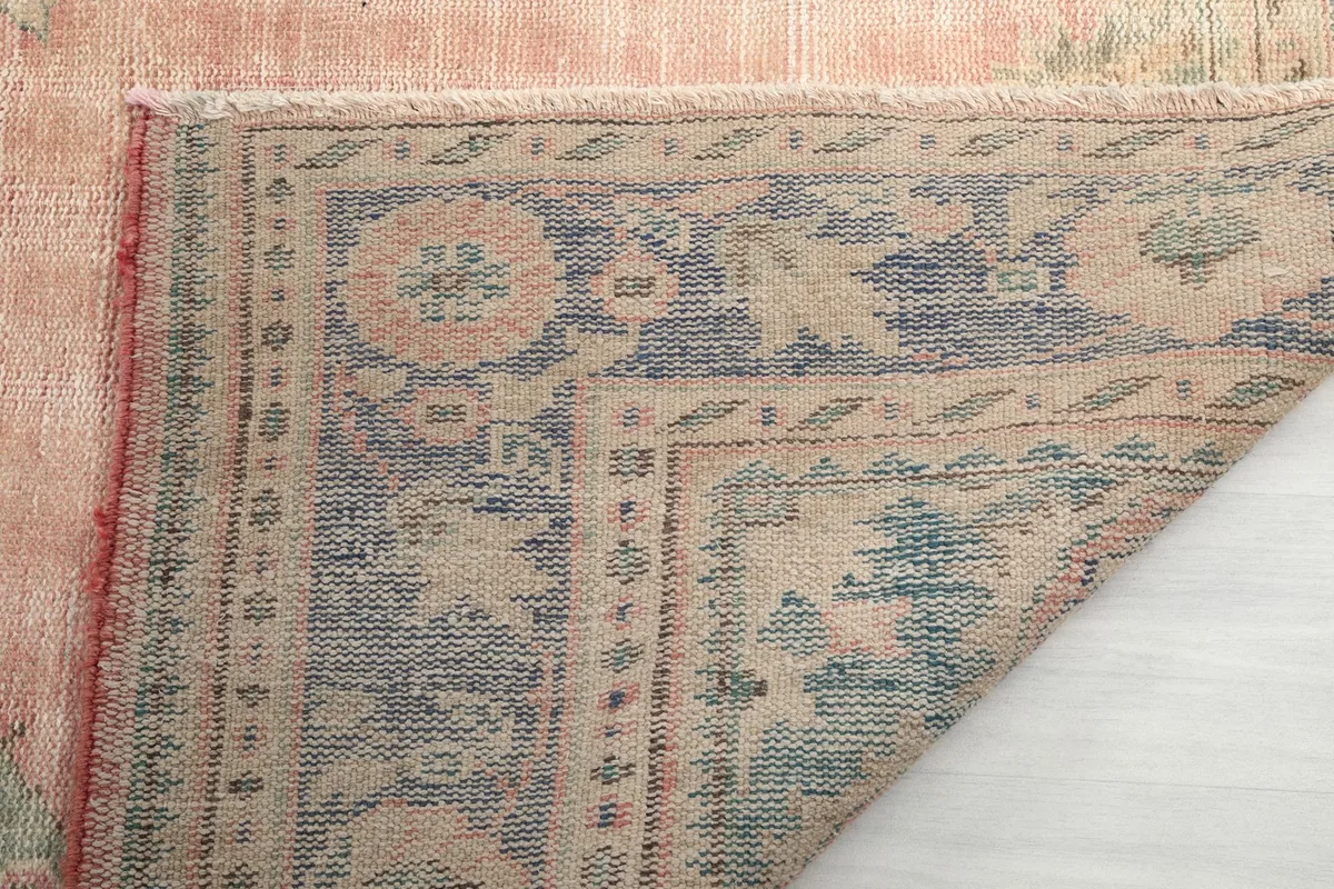 Close-up of the back of the rug, showing the detailed weave and construction of the hand-knotted wool.