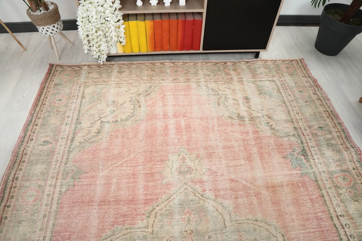 Overhead view showcasing the full pattern and colors of the large vintage rug in a room.