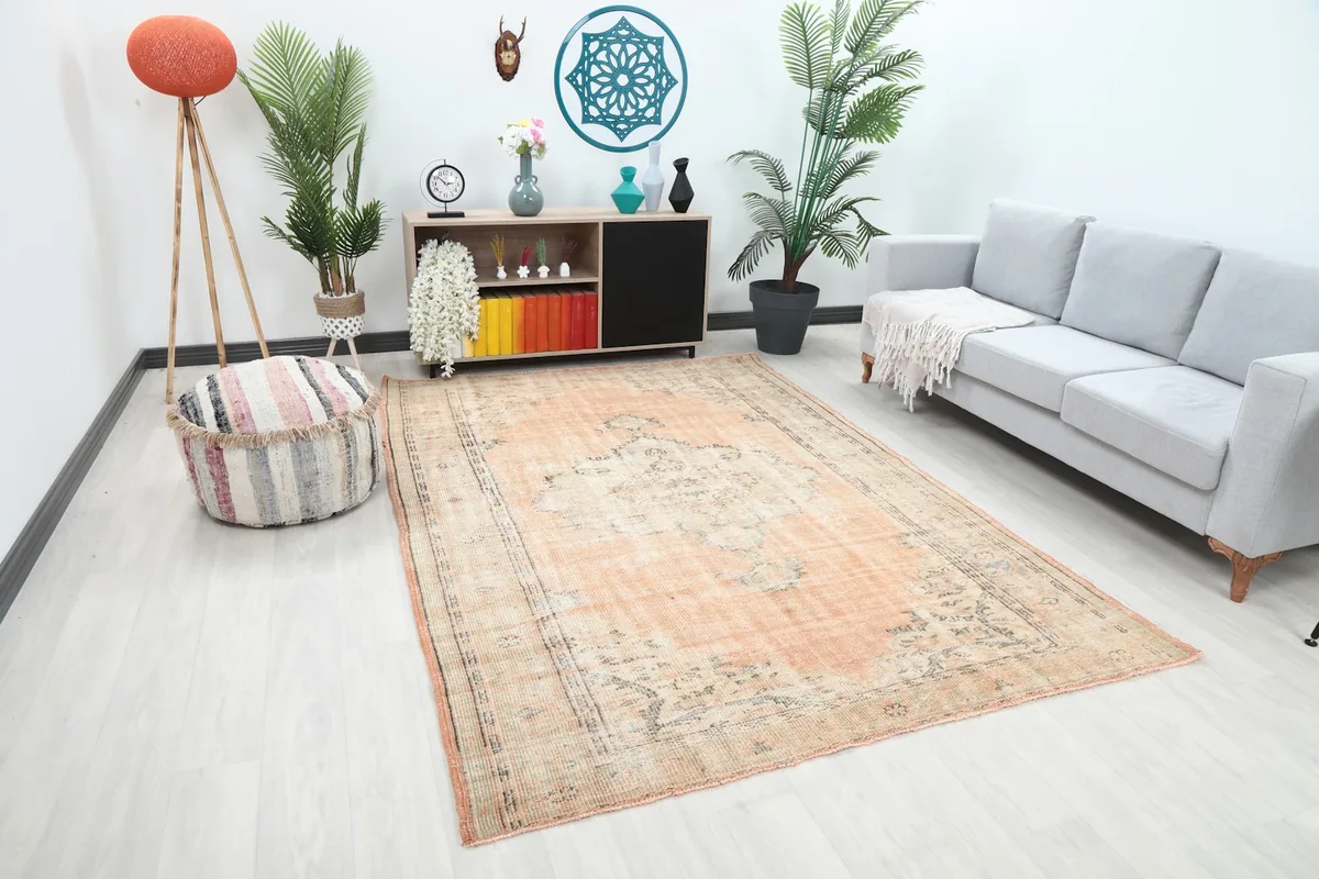 Another angle of the orange Anatolian rug in a living room, showing its placement relative to furniture