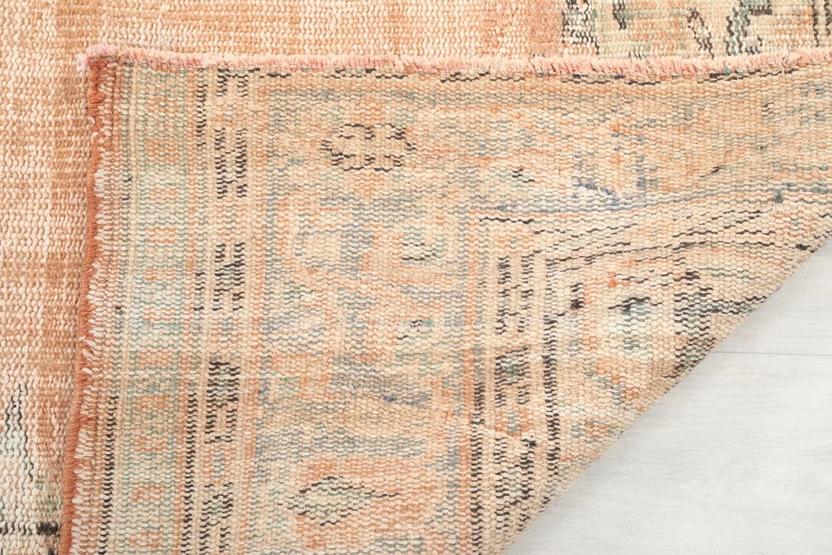Underside of the rug showing the reverse of the hand-knotted pile and cotton foundation