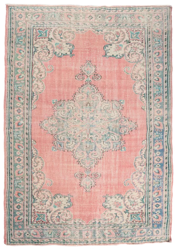 Full top view of the rose and blue vintage Anatolian medallion rug on a white background
