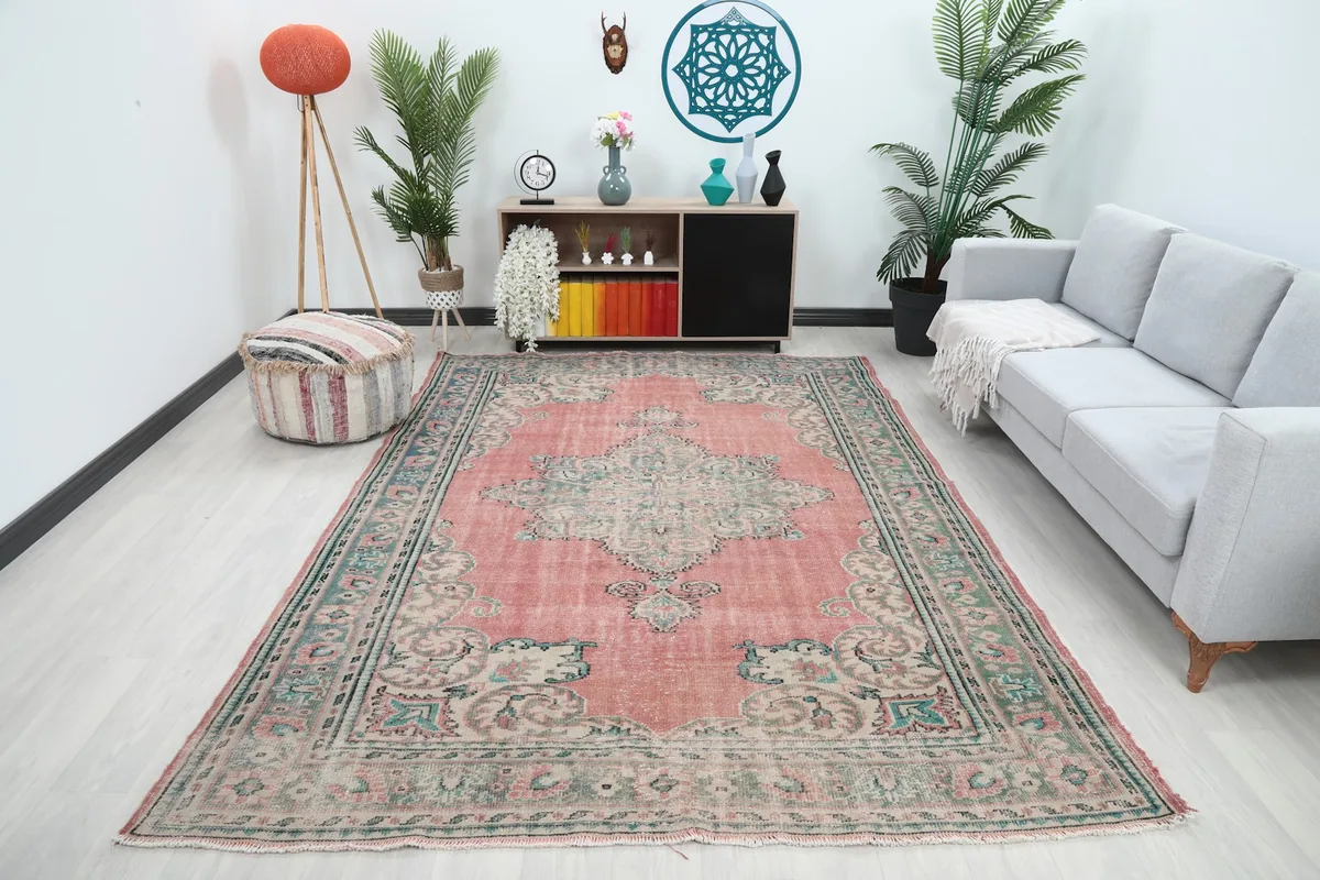 Vintage rose and blue area rug displayed in a modern living room setting