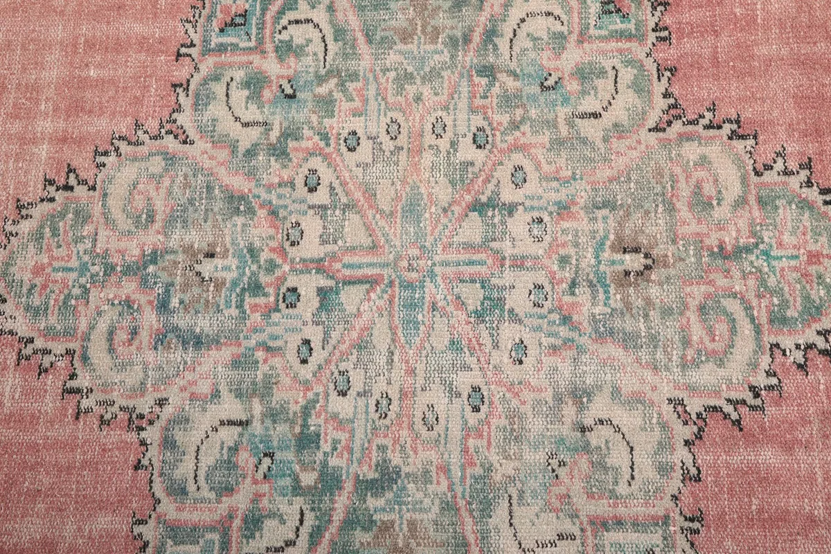 Close-up of the intricate patterns within the central medallion of the rug