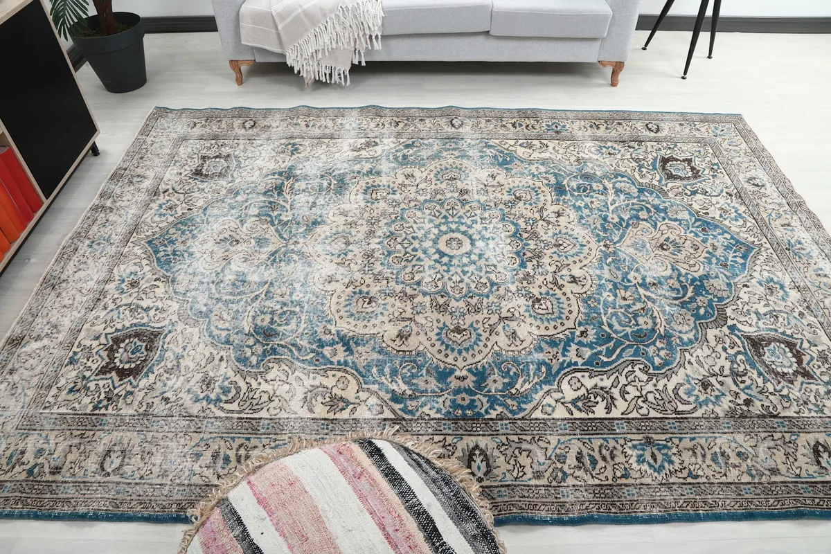 Full room view of the vintage rug, showing its scale and placement with furniture