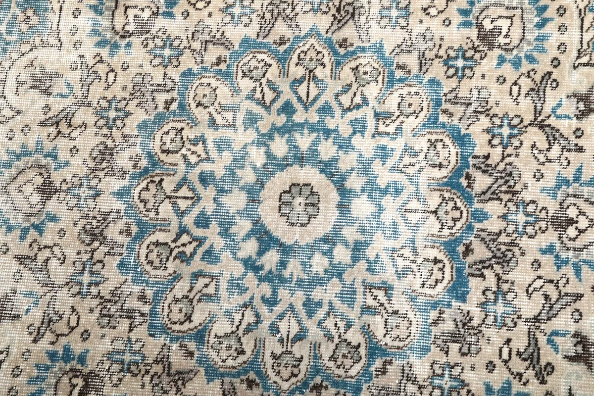 Close-up of the central blue medallion with intricate floral designs