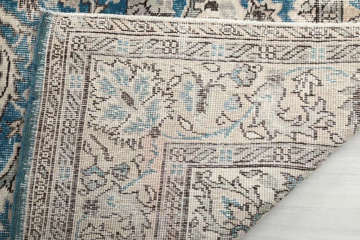Underside of the rug showing the hand-knotted construction and foundation