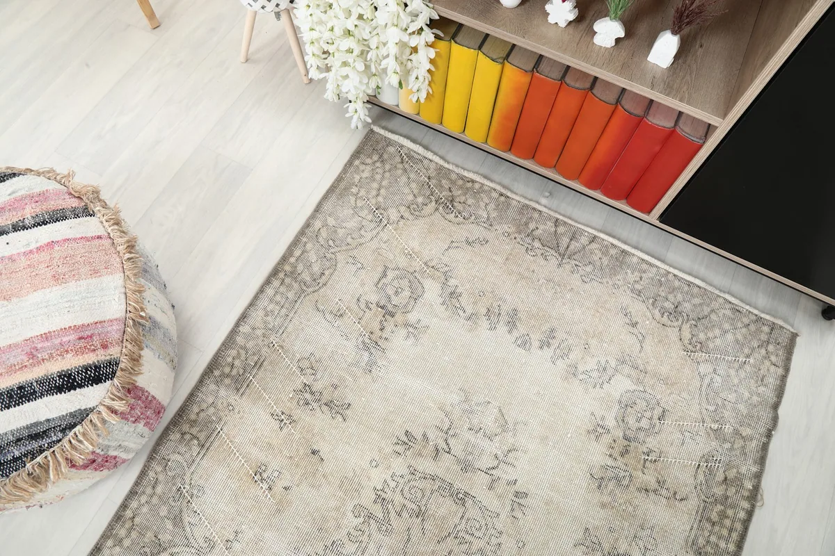 High-angle view of the rug from above, showing its full length and placement next to a pouf