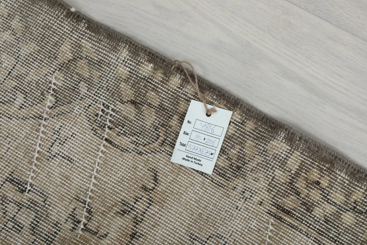 Product tag attached to the back of the rug, indicating its origin and material details