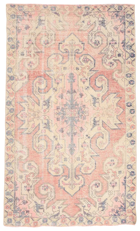 Full overhead view of the vintage Anatolian rug with rose, rust, and beige colors on a white background