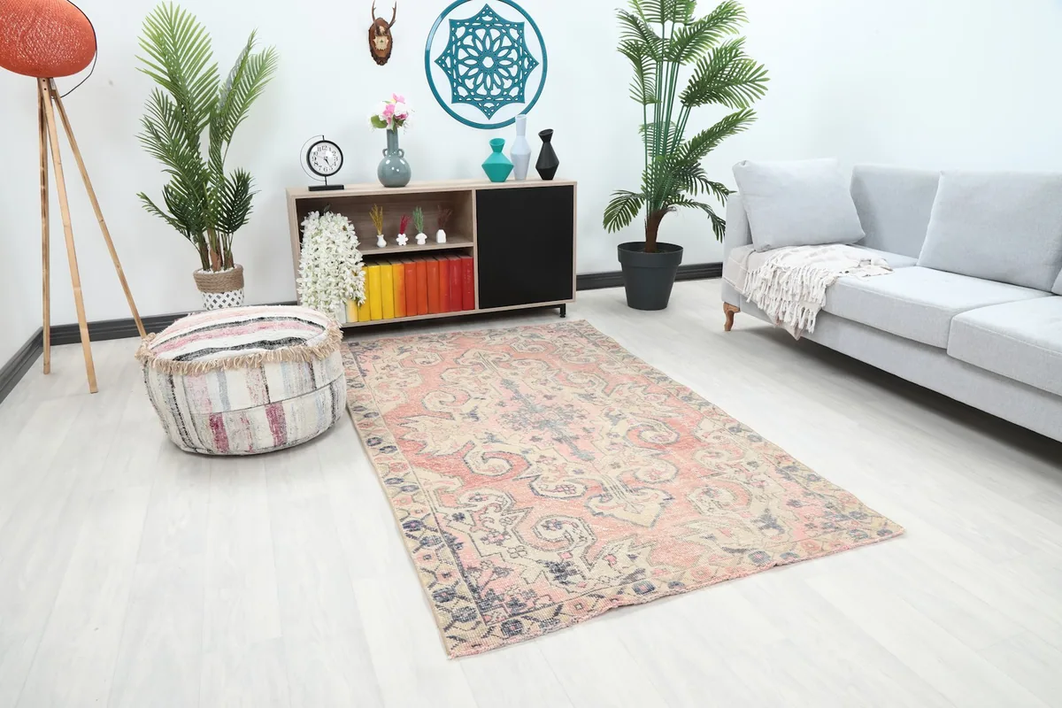 Vintage rug positioned in a room with light flooring, showing its overall scale and colors