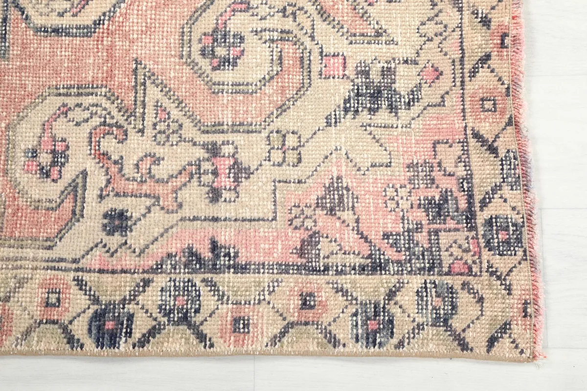 Detailed corner view of the rug, highlighting the border and geometric motifs